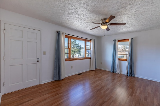 entrance foyer featuring ceiling fan, a textured ceiling, and hardwood / wood-style floors