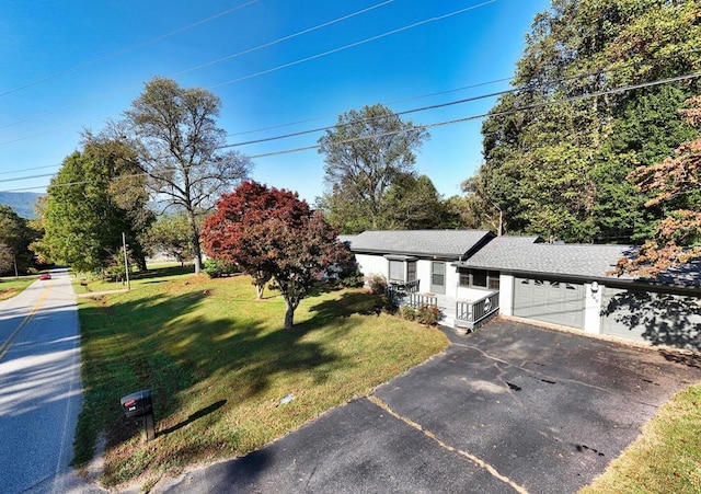 view of front of house with a garage and a front yard