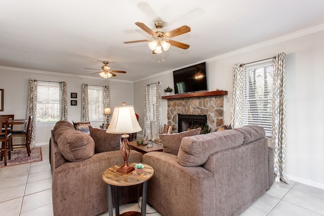 living area with ceiling fan, light tile patterned flooring, baseboards, and ornamental molding