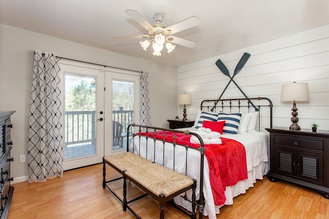 bedroom with access to exterior, french doors, light wood-style floors, baseboards, and ceiling fan