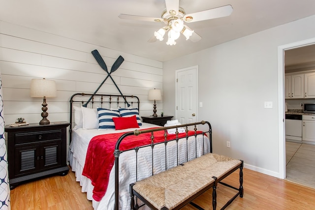 bedroom with light wood finished floors, ceiling fan, and baseboards