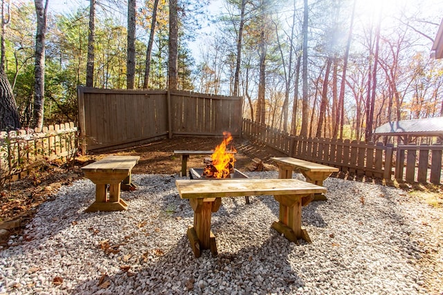 view of yard featuring a fire pit and a fenced backyard