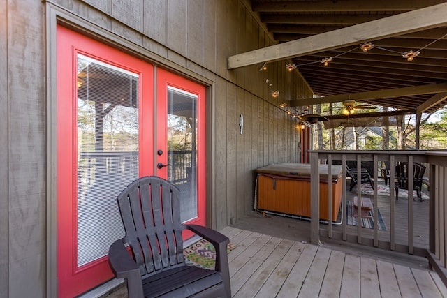 deck featuring french doors and a hot tub