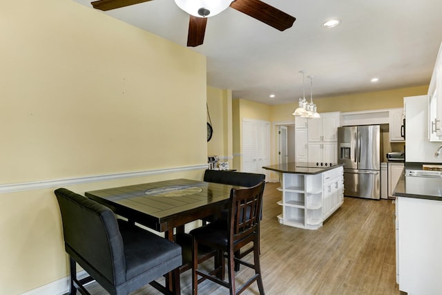 dining area with light wood-style flooring, recessed lighting, baseboards, and ceiling fan