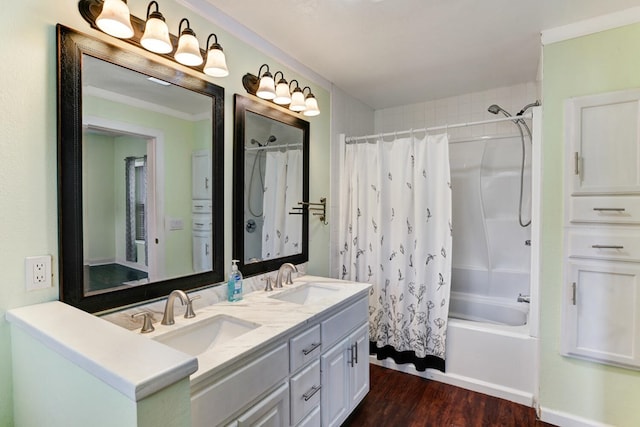 bathroom with a sink, double vanity, wood finished floors, and shower / bath combo