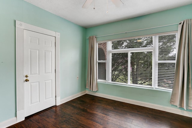 empty room with baseboards, a textured ceiling, a ceiling fan, and hardwood / wood-style flooring