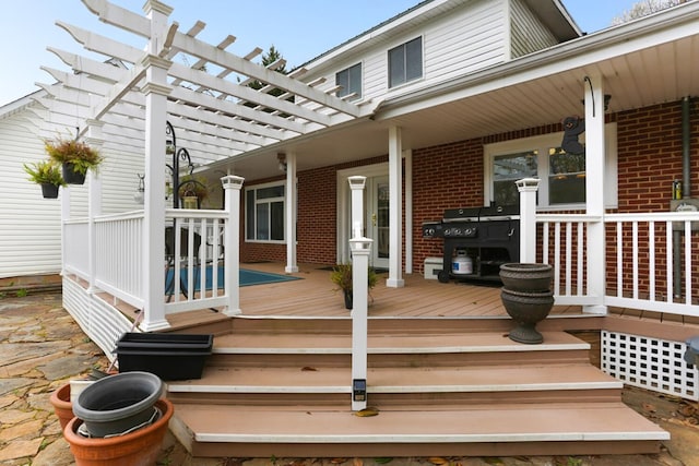 deck featuring covered porch and a pergola