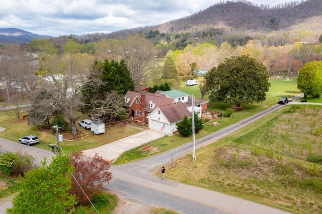 aerial view with a mountain view and a wooded view