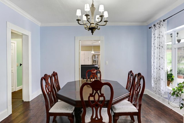 dining room with baseboards, a notable chandelier, wood finished floors, and crown molding