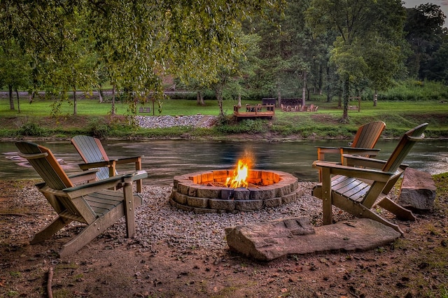 view of patio featuring a fire pit and a water view