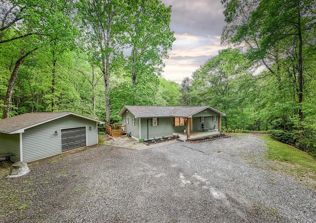 68 Phillips Crk, Andrews, NC 28901 - view of front of home featuring an outdoor structure, a porch, a garage, driveway, and a forest view