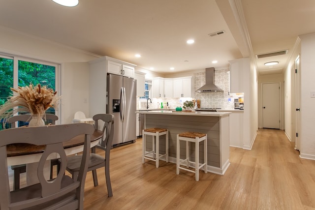 68 Phillips Crk, Andrews, NC 28901 - kitchen with wall chimney range hood, stainless steel refrigerator with ice dispenser, light countertops, white cabinets, and ornamental molding