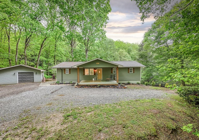 68 Phillips Crk, Andrews, NC 28901 - view of front facade featuring a porch, an outdoor structure, a detached garage, and a forest view