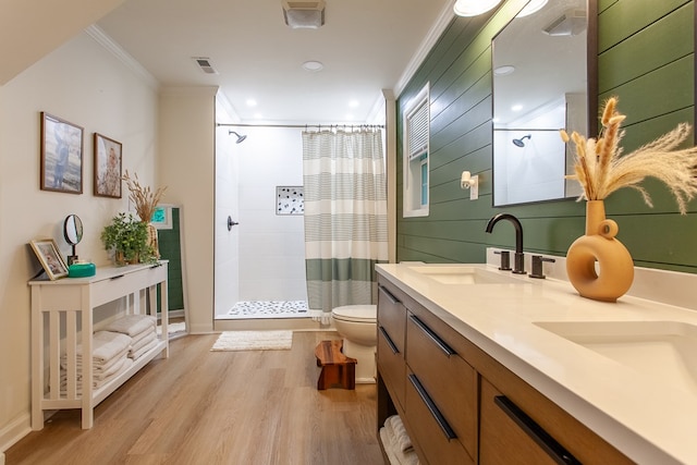 68 Phillips Crk, Andrews, NC 28901 - bathroom with ornamental molding, a tile shower, toilet, wood finished floors, and double vanity