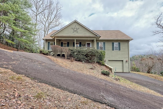 view of front of house with a porch and a garage