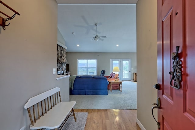 foyer with ceiling fan, light hardwood / wood-style floors, and lofted ceiling