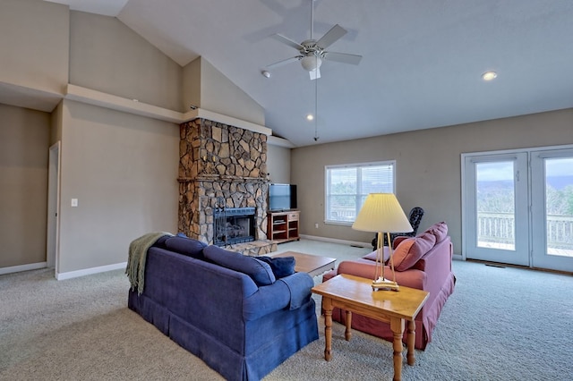 living room featuring a fireplace, ceiling fan, light carpet, and high vaulted ceiling