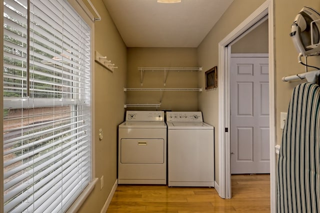 laundry area featuring light wood-type flooring and washing machine and clothes dryer