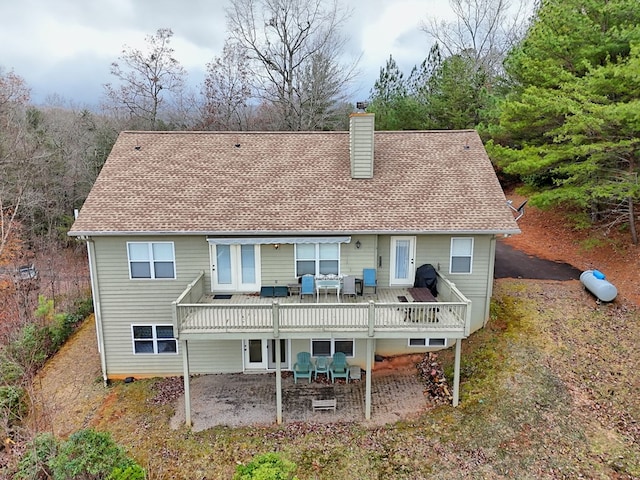 back of property featuring a patio area and a deck