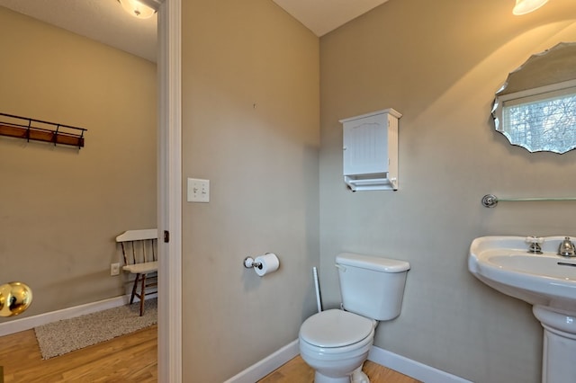 bathroom featuring hardwood / wood-style floors and toilet