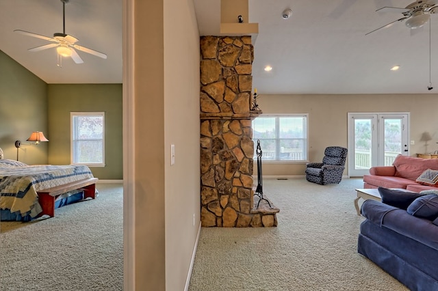 living room featuring carpet, plenty of natural light, and ceiling fan