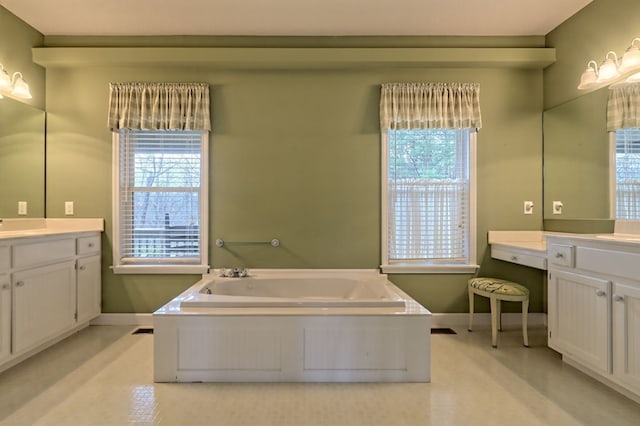 bathroom with vanity, a tub to relax in, and a wealth of natural light