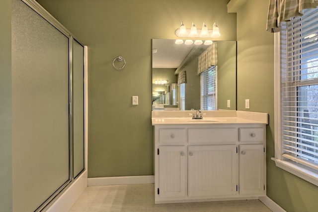 bathroom featuring vanity and a shower with door