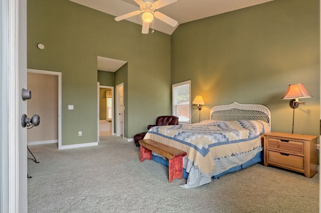 carpeted bedroom featuring high vaulted ceiling and ceiling fan