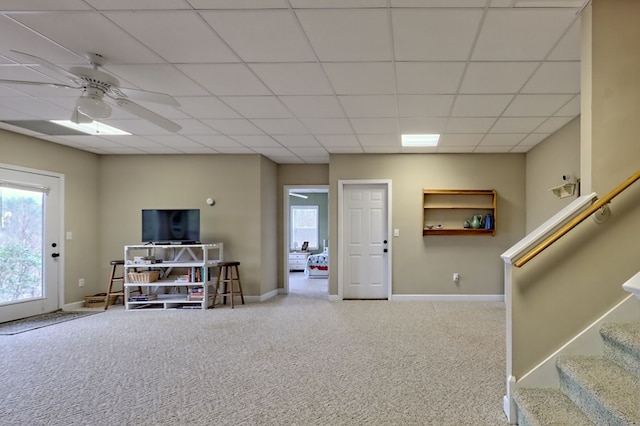 interior space featuring ceiling fan and a drop ceiling