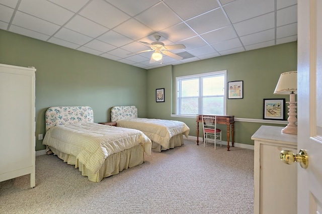 bedroom with a paneled ceiling, ceiling fan, and carpet floors