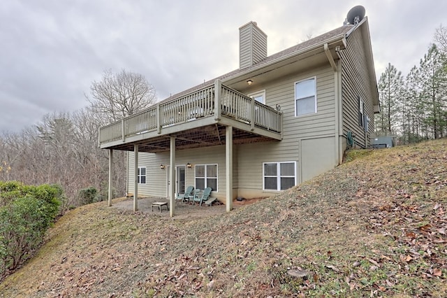 rear view of house featuring a deck