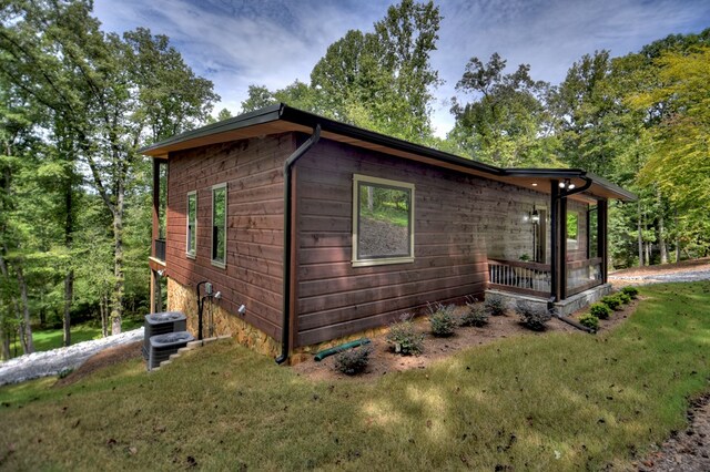 view of property exterior featuring a yard and central AC