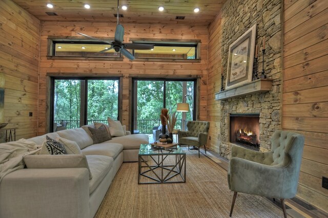 living room with a healthy amount of sunlight, ceiling fan, hardwood / wood-style flooring, and a fireplace