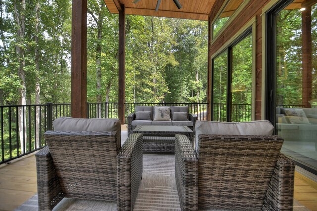 unfurnished sunroom featuring ceiling fan and wooden ceiling