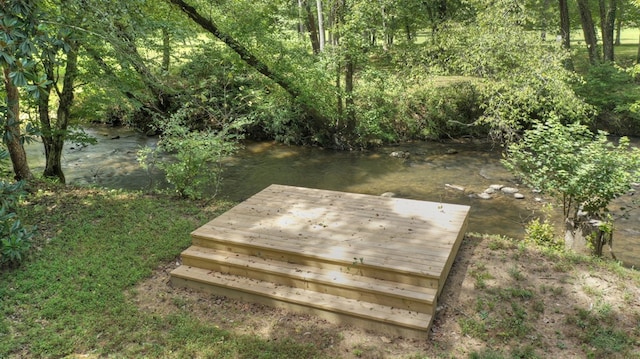 wooden terrace featuring a water view