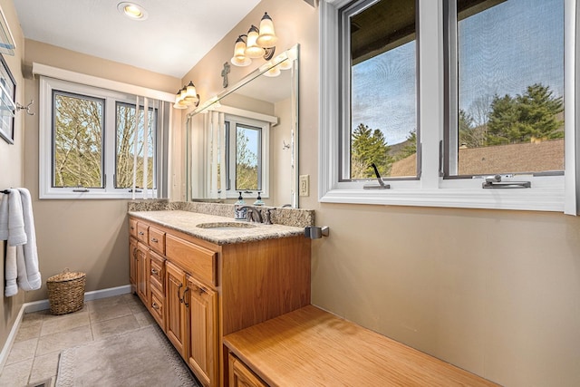 bathroom with tile patterned flooring, vanity, and baseboards