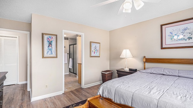 bedroom featuring baseboards, connected bathroom, ceiling fan, wood finished floors, and a textured ceiling