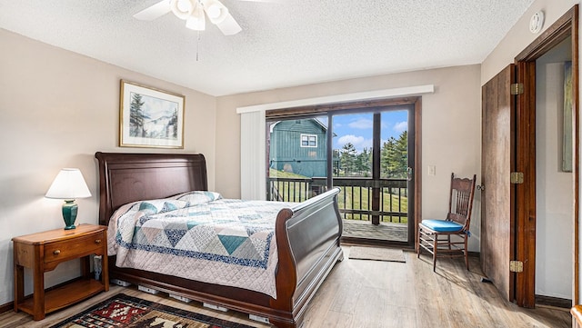 bedroom featuring a textured ceiling, ceiling fan, baseboards, light wood-style floors, and access to outside