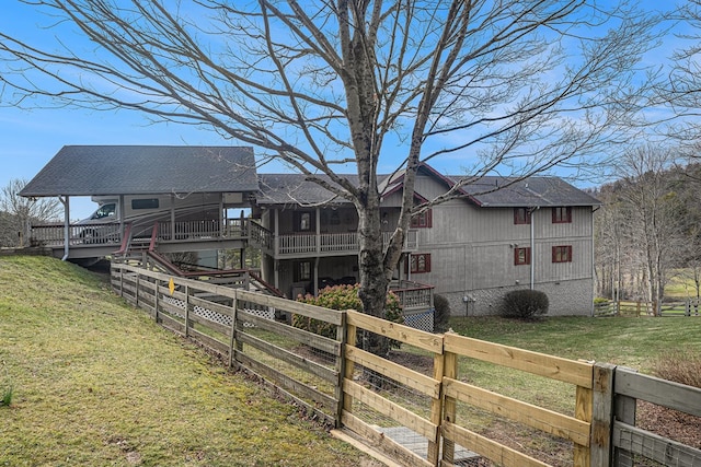 exterior space with fence and a front lawn