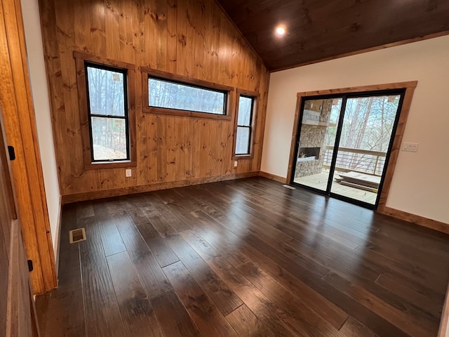 spare room with wood ceiling, visible vents, baseboards, vaulted ceiling, and dark wood-type flooring
