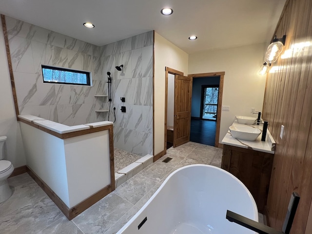 full bath with walk in shower, recessed lighting, toilet, and a soaking tub
