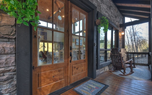 view of exterior entry featuring stone siding