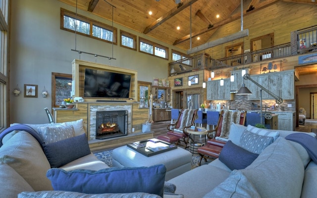 living area featuring high vaulted ceiling, a multi sided fireplace, beamed ceiling, wooden ceiling, and recessed lighting