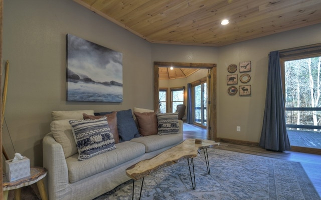 living room with baseboards, wooden ceiling, wood finished floors, and a wealth of natural light