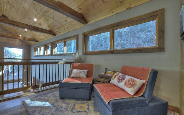 sitting room featuring vaulted ceiling with beams, wooden ceiling, and wood finished floors