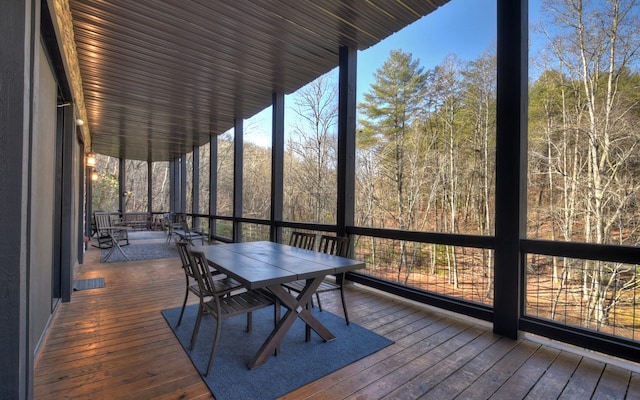 sunroom featuring outdoor dining space