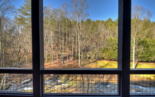 exterior details with a wooded view