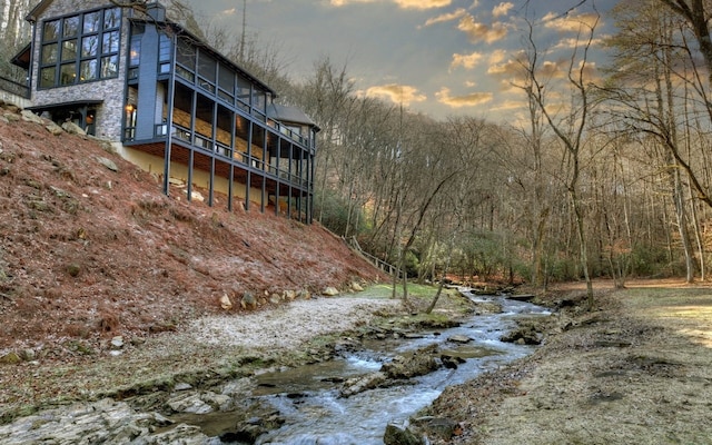 view of building exterior with a forest view