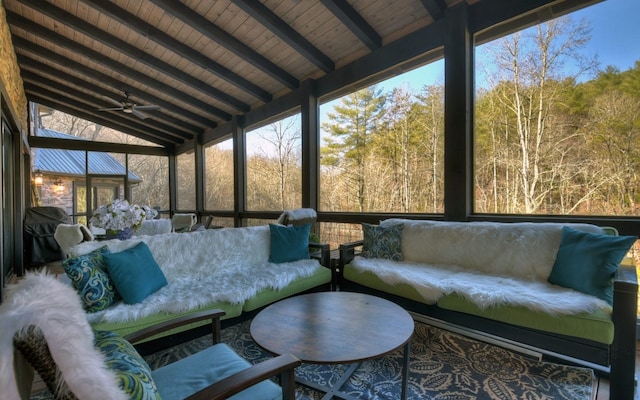 sunroom / solarium with an outdoor living space, beam ceiling, and ceiling fan
