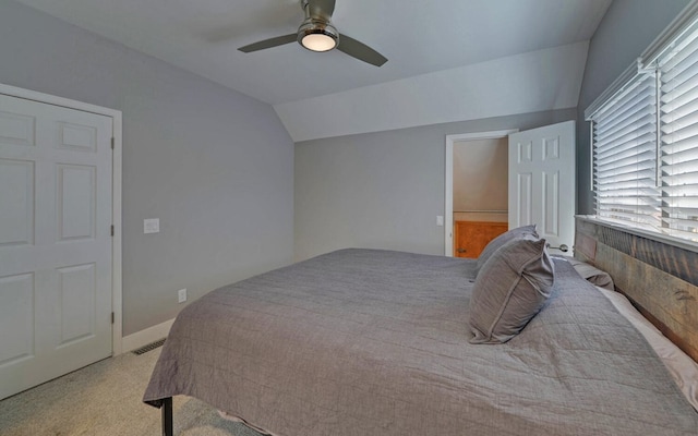 carpeted bedroom featuring vaulted ceiling and ceiling fan